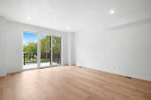 Unfurnished room with light hardwood / wood-style floors and a textured ceiling