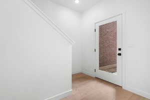 Foyer entrance with light wood-type flooring