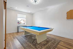 Playroom with hardwood / wood-style floors and pool table