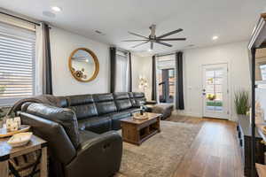 Living room with ceiling fan and wood-type flooring