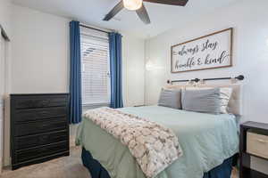 Bedroom with ceiling fan and carpet floors