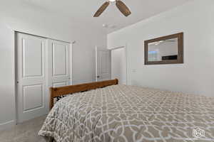 Bedroom featuring carpet flooring, ceiling fan, and a closet