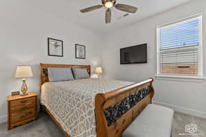 Bedroom with ceiling fan and carpet