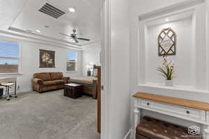 Interior space with a tray ceiling and ceiling fan