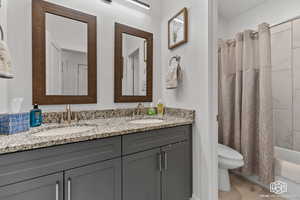 Full bathroom featuring tile patterned flooring, vanity, toilet, and shower / bath combo