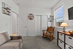 Sitting room featuring light colored carpet