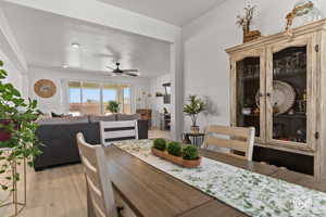 Dining area with ceiling fan and light hardwood / wood-style flooring