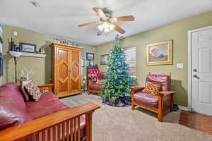 Family room featuring carpet and ceiling fan