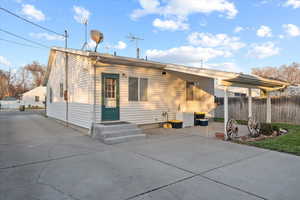 Back of property featuring a covered patio