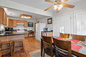 Dining space featuring ceiling fan.