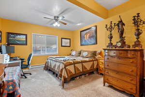 Bedroom featuring light colored carpet, and ceiling fan