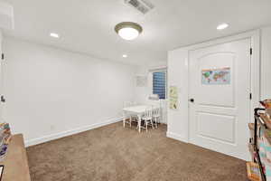 Entryway with carpet and a textured ceiling