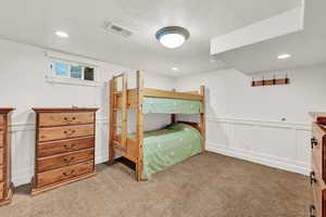 Bedroom featuring carpet and a textured ceiling