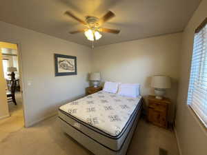 Bedroom featuring light carpet and ceiling fan