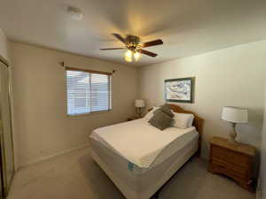 Bedroom with ceiling fan and carpet floors