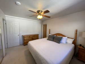 Bedroom featuring ceiling fan and light colored carpet