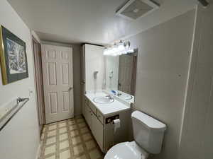 Bathroom featuring vanity and toilet