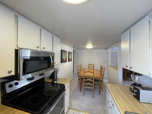 Kitchen with white cabinets and stainless steel appliances