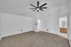 Interior space featuring ceiling fan, light colored carpet, sink, and high vaulted ceiling