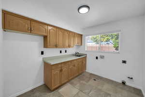 Laundry area with sink, cabinets, washer hookup, electric dryer hookup, and gas dryer hookup