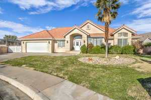 View of front of home featuring a garage and a front lawn