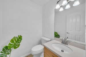 Bathroom featuring tile patterned flooring, vanity, and toilet