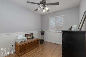 Home office with ceiling fan and light hardwood / wood-style floors