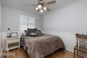 Bedroom featuring wood-type flooring and ceiling fan