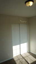 Unfurnished bedroom with carpet and a closet