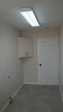 Laundry area with hookup for an electric dryer and cabinets