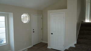 Foyer featuring lofted ceiling and hardwood / wood-style flooring