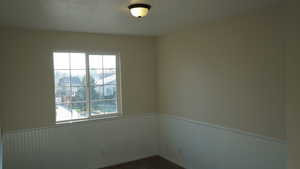 Empty room with plenty of natural light and carpet floors