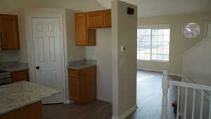 Kitchen with light stone countertops and wood-type flooring