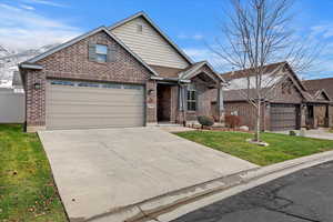 View of property with a garage and a front lawn