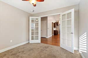 Unfurnished room featuring ceiling fan, french doors, vaulted ceiling, and hardwood / wood-style flooring