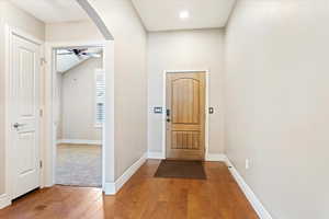 Interior space with ceiling fan and hardwood floors