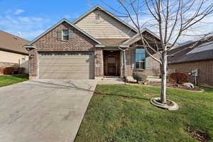 View of front facade with a garage and a front lawn