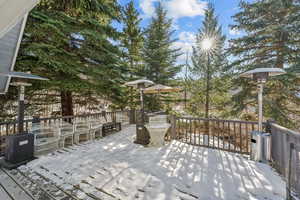 Snow covered deck with an outdoor hangout area