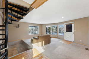 Unfurnished living room with light colored carpet