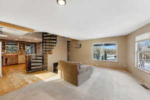 Carpeted living room with plenty of natural light and sink