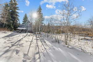 Snowy yard featuring a garage