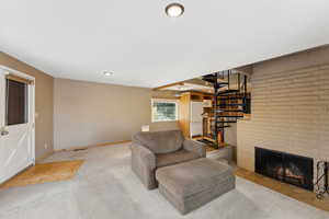 Carpeted living room with a fireplace