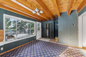 Interior space with beam ceiling and wooden walls