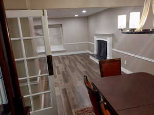 Unfurnished living room with a chandelier and wood-type flooring