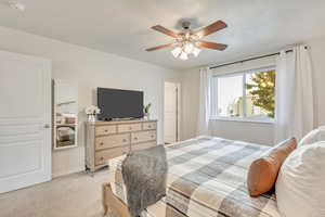 Carpeted bedroom with ceiling fan