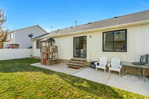 Back of property featuring a patio and a lawn