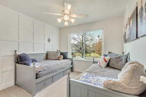 Bedroom featuring ceiling fan and light carpet