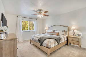 Bedroom featuring ceiling fan and light carpet