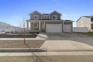 View of front facade with a porch and a garage