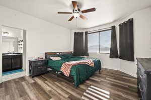 Bedroom featuring ensuite bath, ceiling fan, dark hardwood / wood-style flooring, and sink